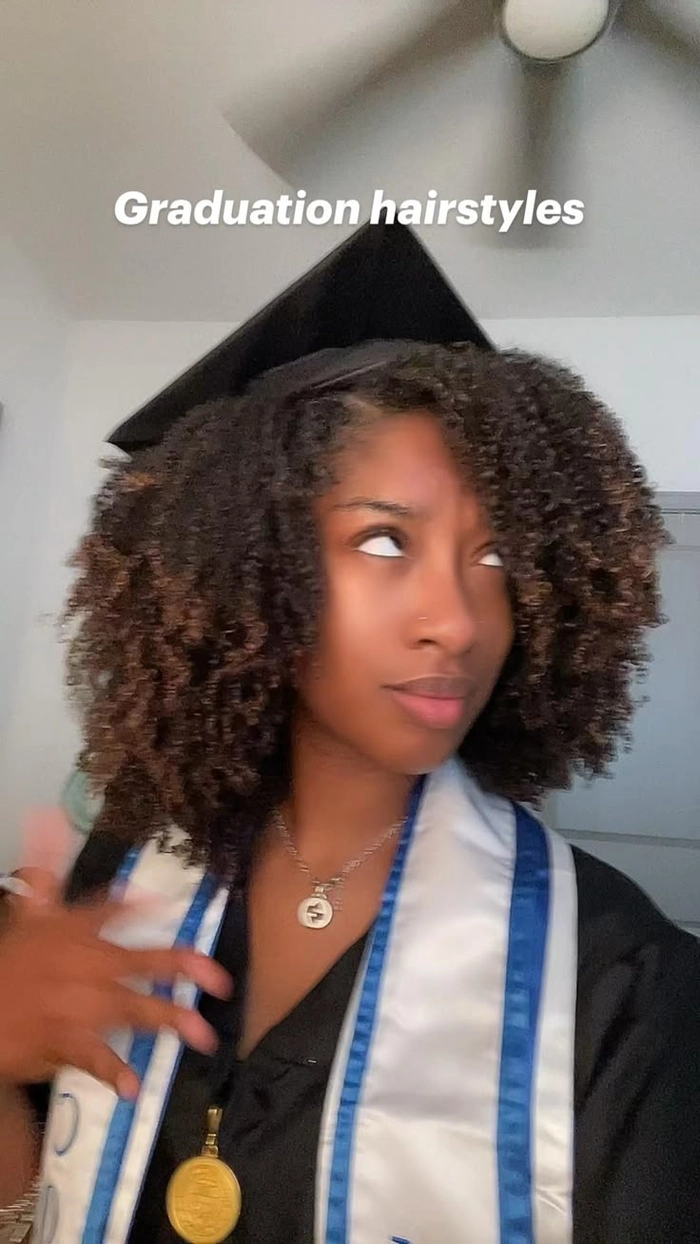 A rain-resistant graduation hairstyle with pinned curls and a secure updo