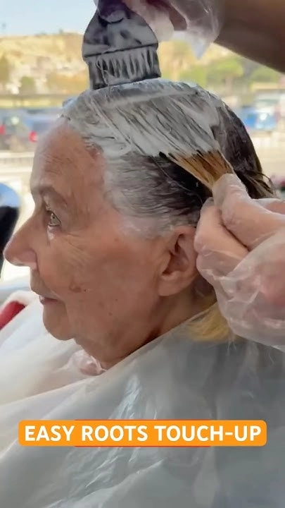 A close-up of a graduation hairstyle with freshly touched-up roots for even color.