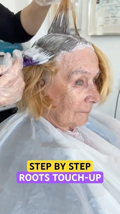 A close-up of a graduation hairstyle with subtle root touch-up blending for a polished look