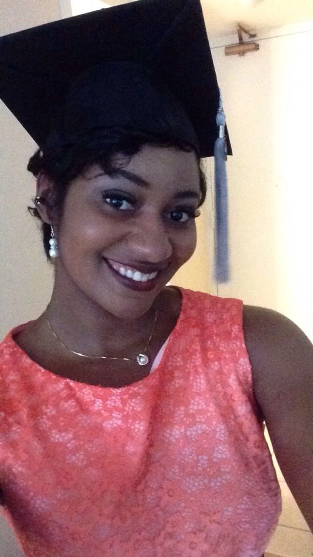 Woman with short hair securing graduation cap with bobby pins