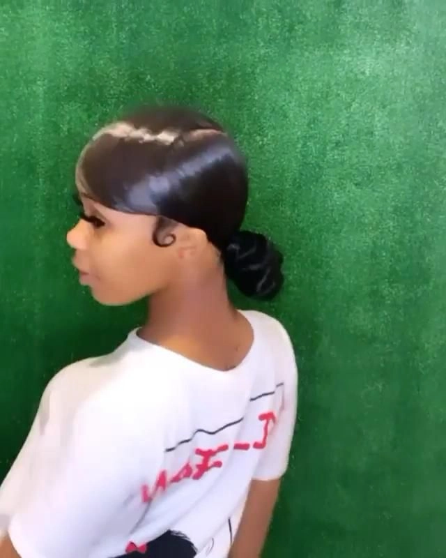 Sleek low ponytail graduation hairstyle with smooth strands and a polished finish
