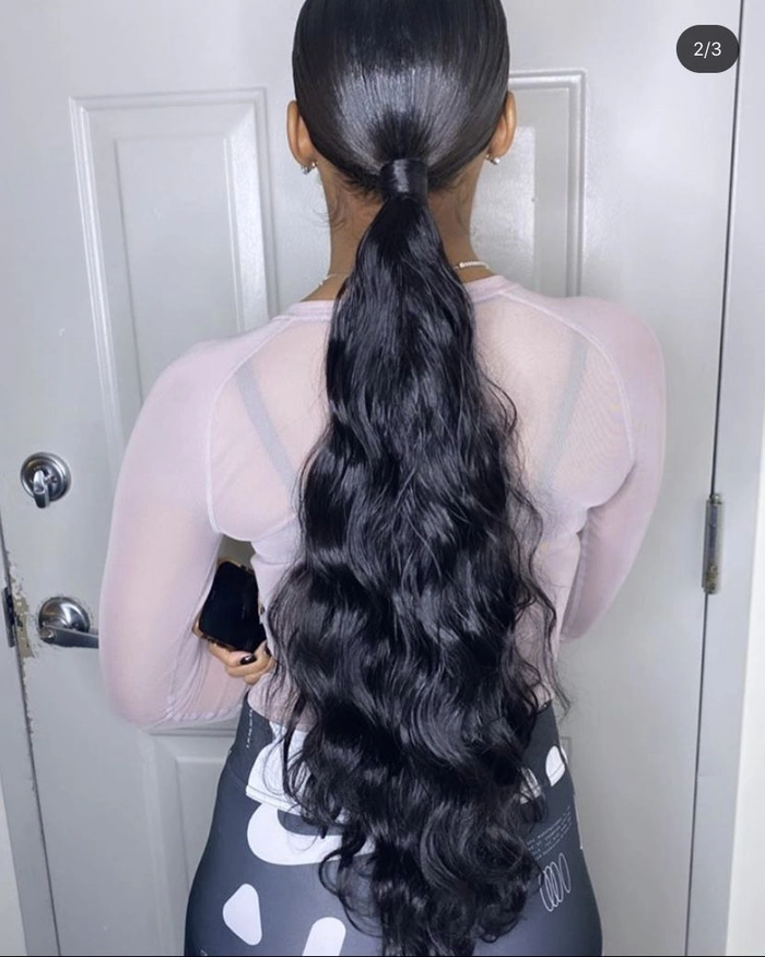 Sleek low ponytail graduation hairstyle with a center part and smooth finish