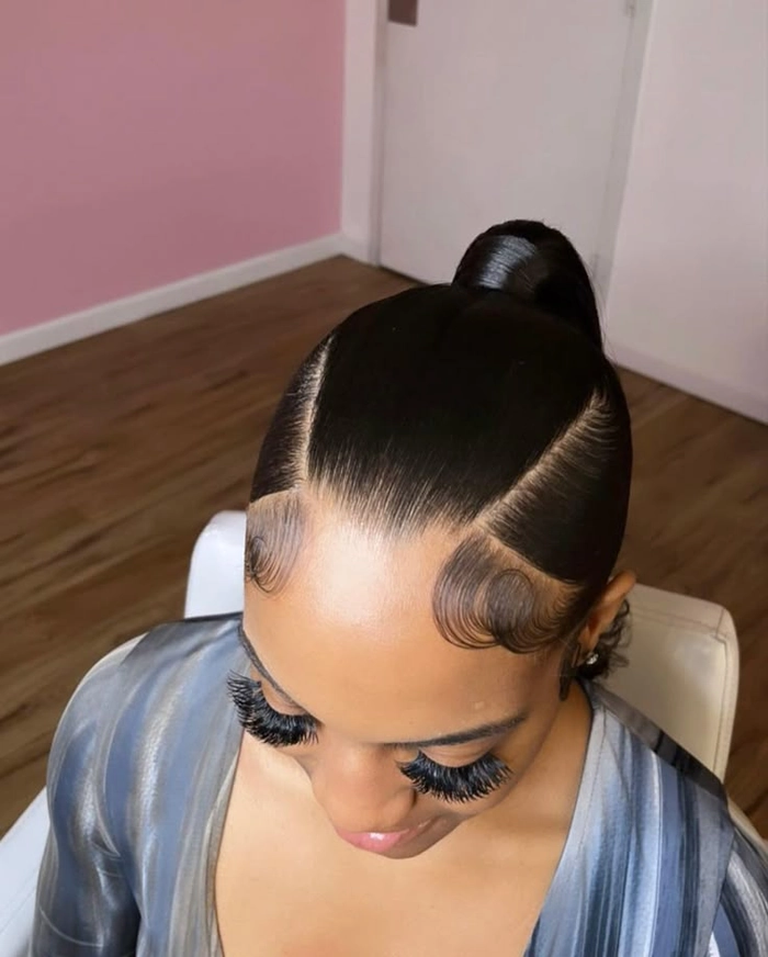 Sleek low ponytail graduation hairstyle with polished finish
