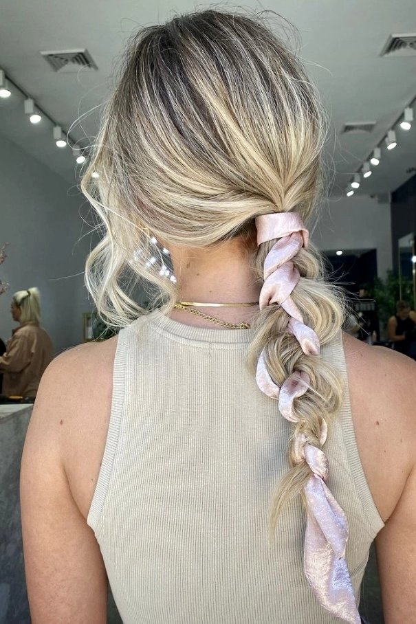 Elegant hot weather graduation updo with breathable braided crown Light summer graduation hairstyle with loose braids and floral pins