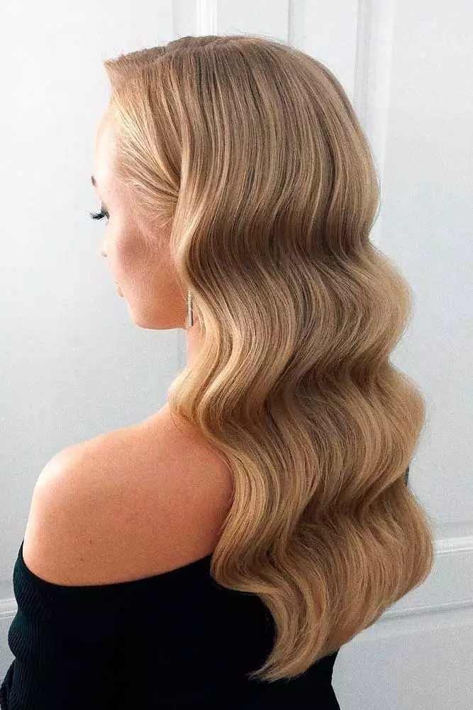Vintage-inspired graduation updo with soft curls and pearl pins