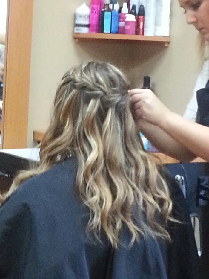 Elegant waterfall braid hairstyle for graduation with loose flowing strands