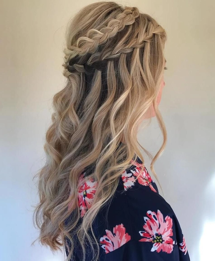 Elegant waterfall braid accented with flowers for a graduation ceremony
