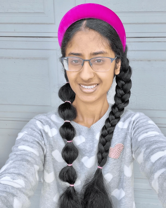 Festive bubble braid ponytail with ribbon details for Christmas or New Year Playful bubble braid ponytail hairstyle for holiday party celebrations