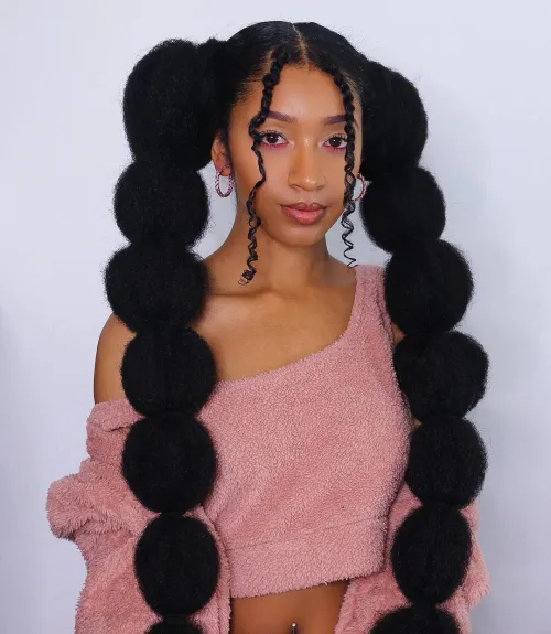 Playful bubble braid ponytail perfect for festive holiday celebrations Playful bubble braid ponytail hairstyle with festive accessories for a holiday party