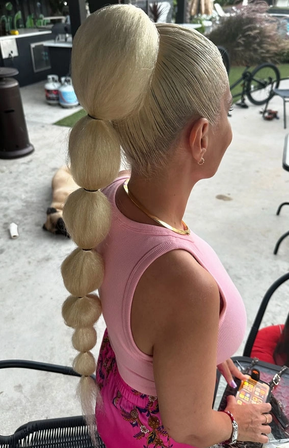 Playful bubble braid ponytails - a joyful holiday hairstyle for parties Two playful bubble braid ponytails styled for a festive holiday party