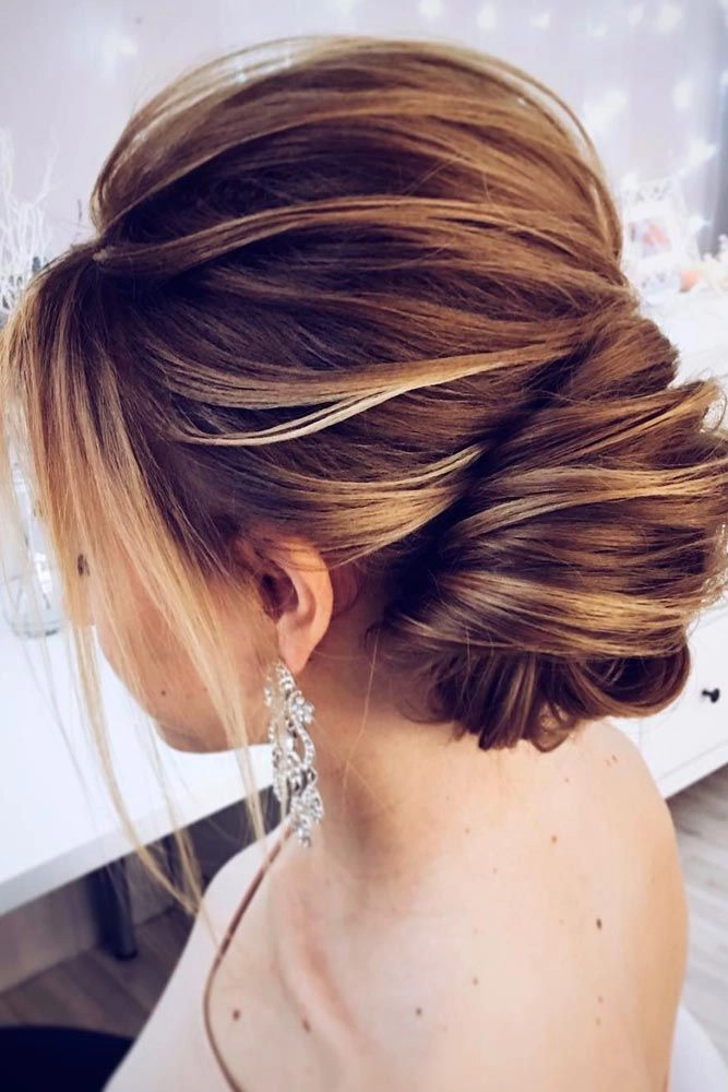 A festive updo hairstyle for long hair, adorned with sparkly accessories at a Christmas party.