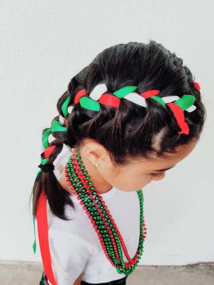 Festive braided updo with colorful flowers for Cinco de Mayo celebration