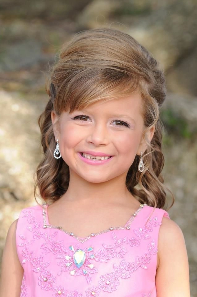 Child wearing a comfortable updo hairstyle for a holiday pageant