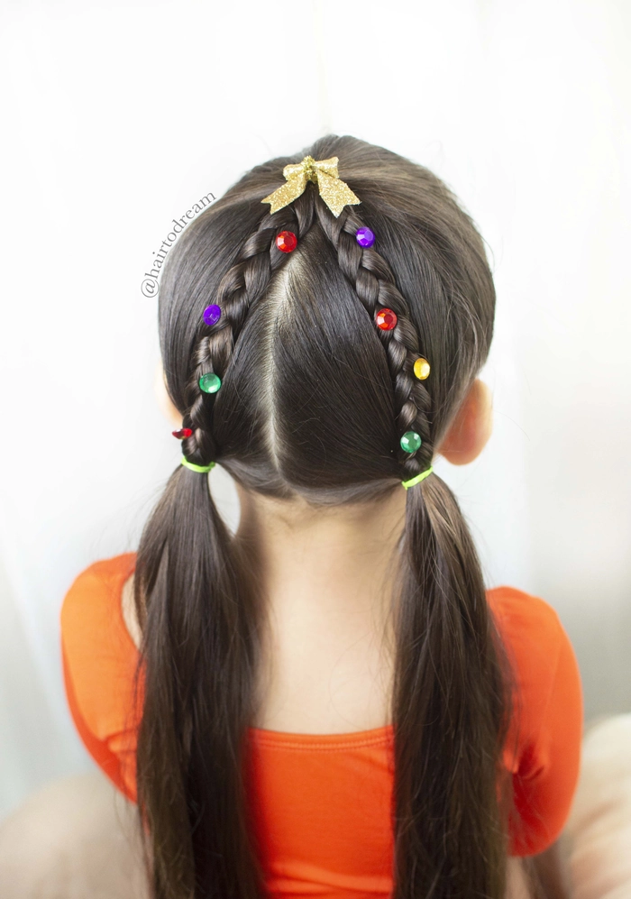 Cute toddler with an easy holiday hairstyle featuring tiny braids and festive hair clips