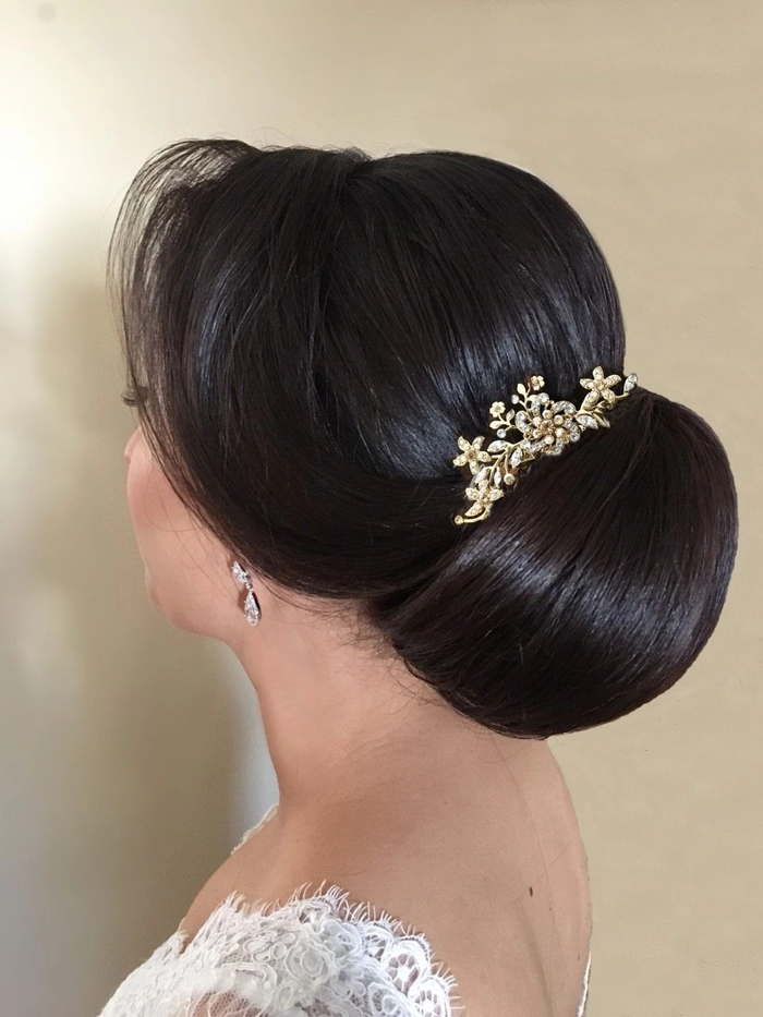 Elegant chignon hairstyle for a winter wedding with delicate accessories