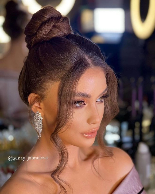 Elegant gray hair styled in a sophisticated updo for a holiday formal event