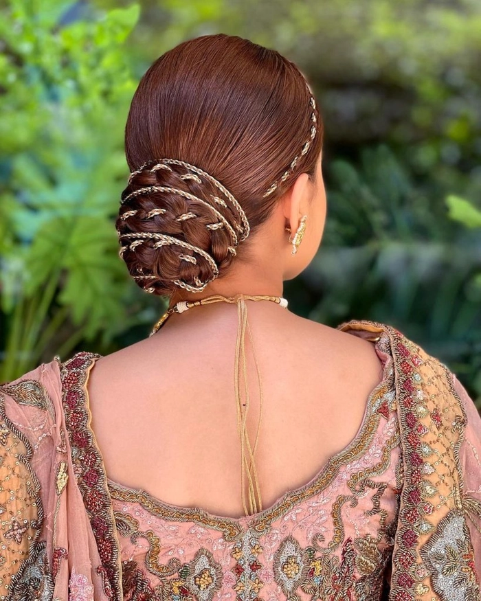 Elegant Updo Hairstyle for Diwali Celebrations with Floral Accents Elegant Diwali updo with gold hair accessories and traditional silk flowers