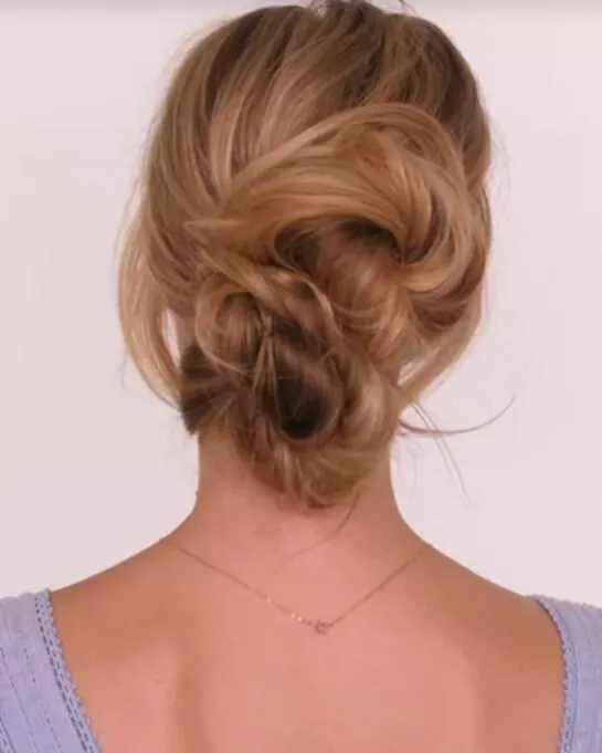Stylish Diwali celebration updo featuring intricate braids Elegant updo with gold hair accessories for Diwali festive look