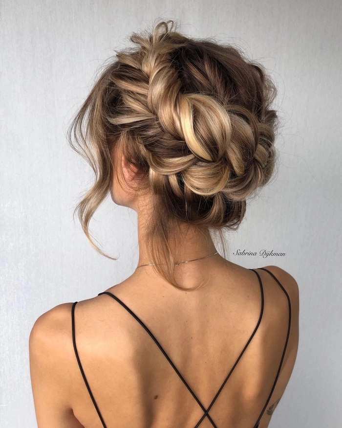 Woman with a festive braided crown hairstyle at a holiday brunch celebration
