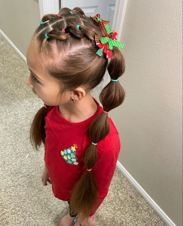 Little girl wearing festive braided pigtails for a holiday celebration