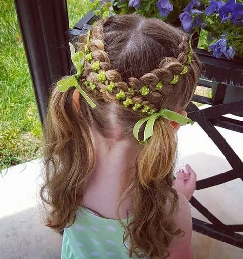 Little girl with festive braided pigtails for a holiday hairstyle