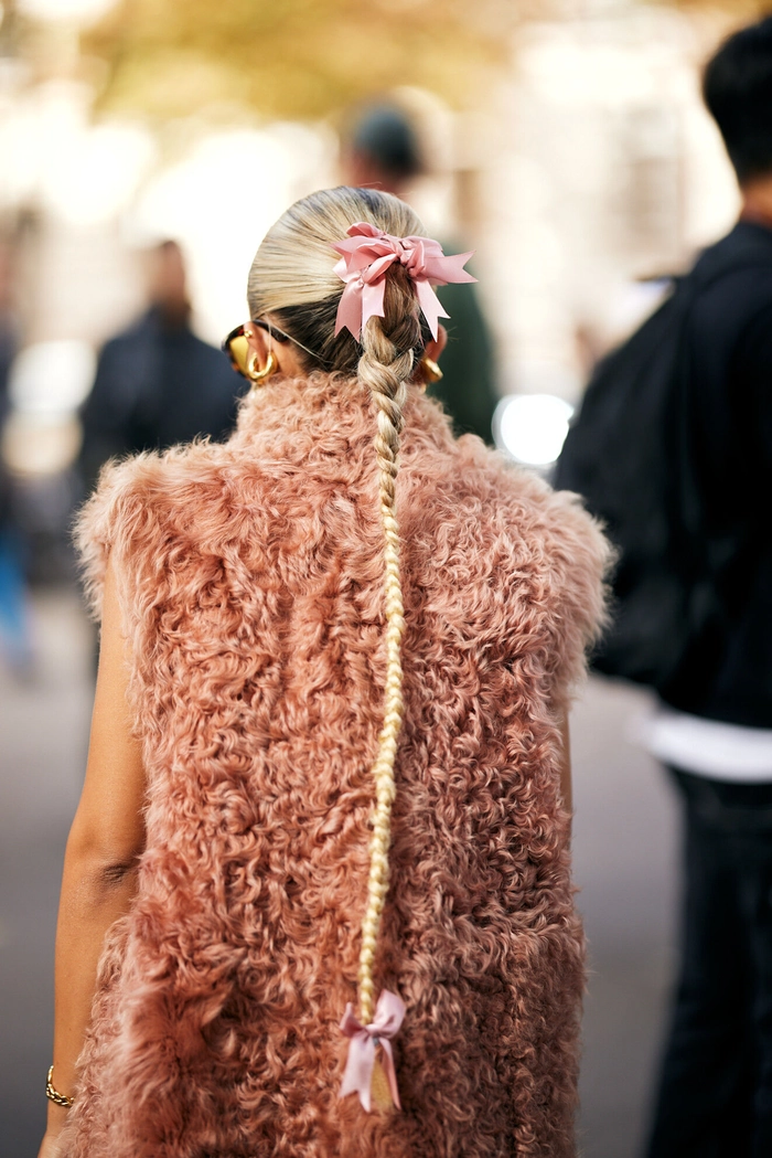 Festive holiday hairstyle with glittering hairpins and pearls for Eid celebrations A woman wearing festive hair accessories for Eid gatherings, including gold clips and a floral headband