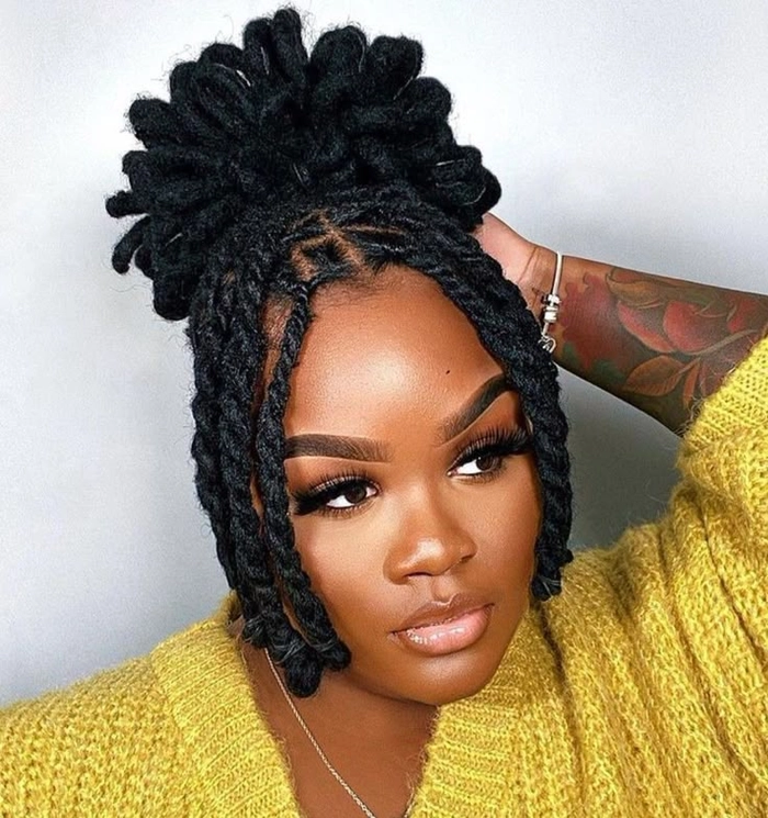Dreadlocks adorned with festive winter accessories like holly and glitter for holiday events