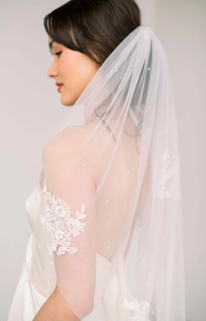 Winter Wedding Veil Placement for a Festive Holiday Hairstyle Veil placement on a festive winter wedding hairstyle with holiday sparkle