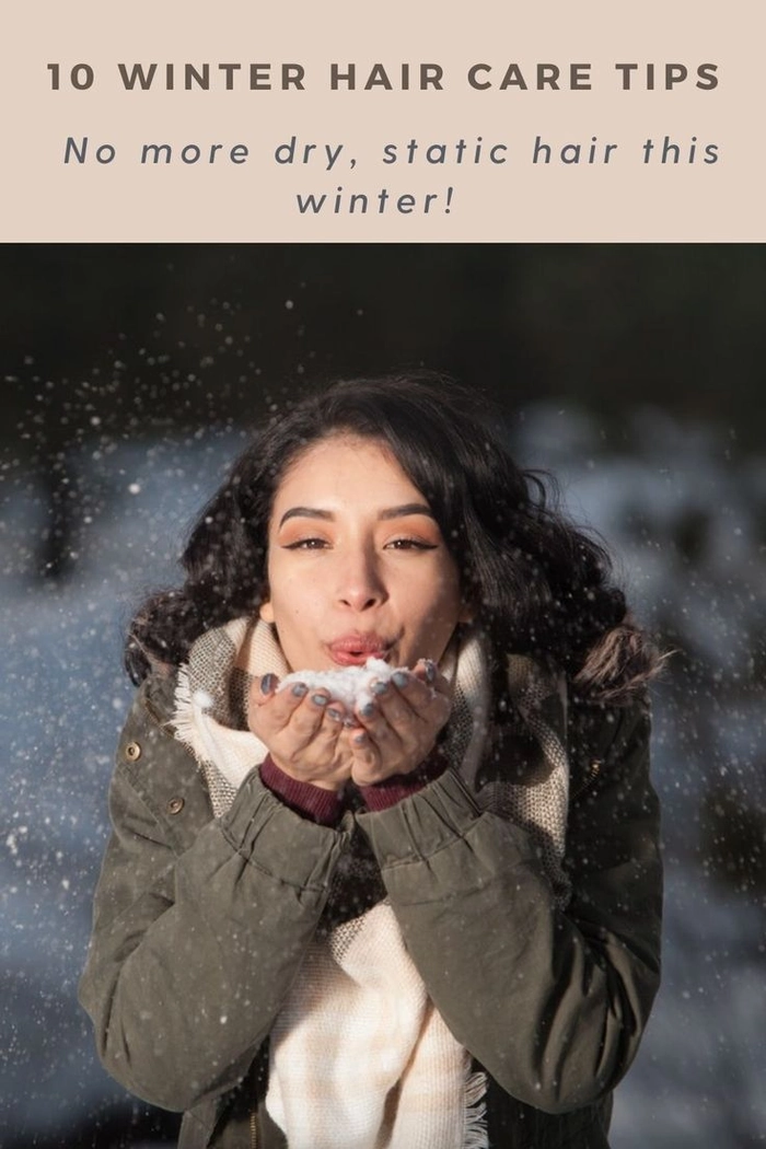 Winter holiday hair maintenance tip: protect your style from cold, dry air and static Woman gently applying moisturizing serum to her hair before heading out for a winter holiday gathering