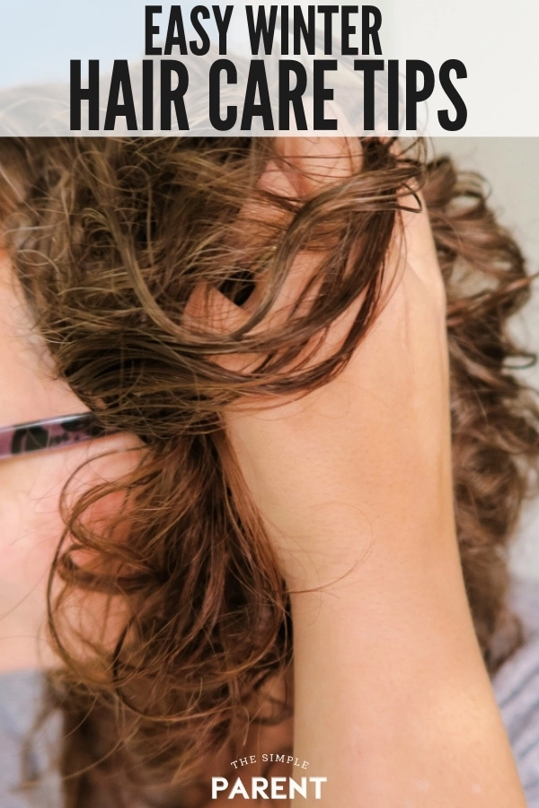Holiday hair maintenance tip: shield your hair from winter chill with a scarf Woman protecting her hair with a silk scarf while stepping out in cold winter weather for holiday celebrations