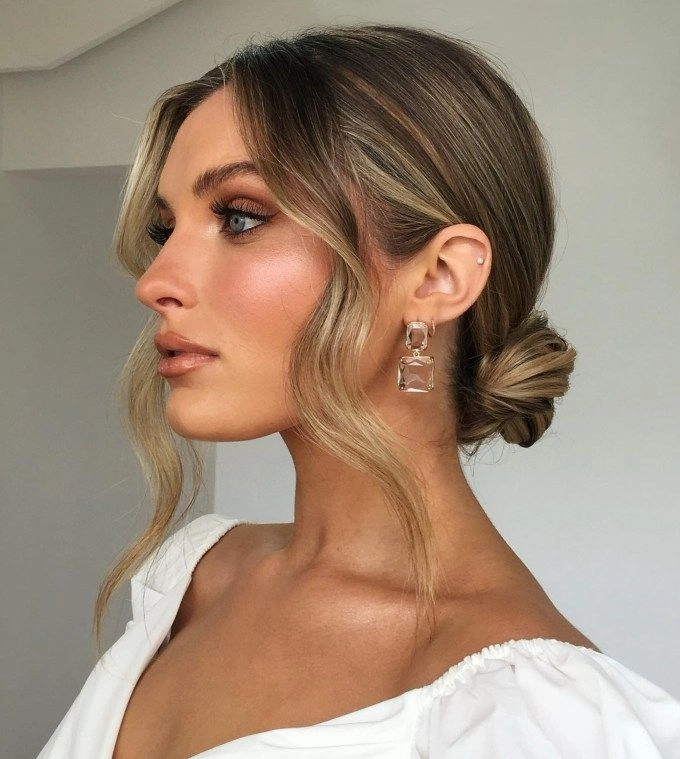 Holiday wedding guest hair inspiration with a romantic half-up style Elegant holiday wedding guest hairstyle with soft curls and glittering accessories