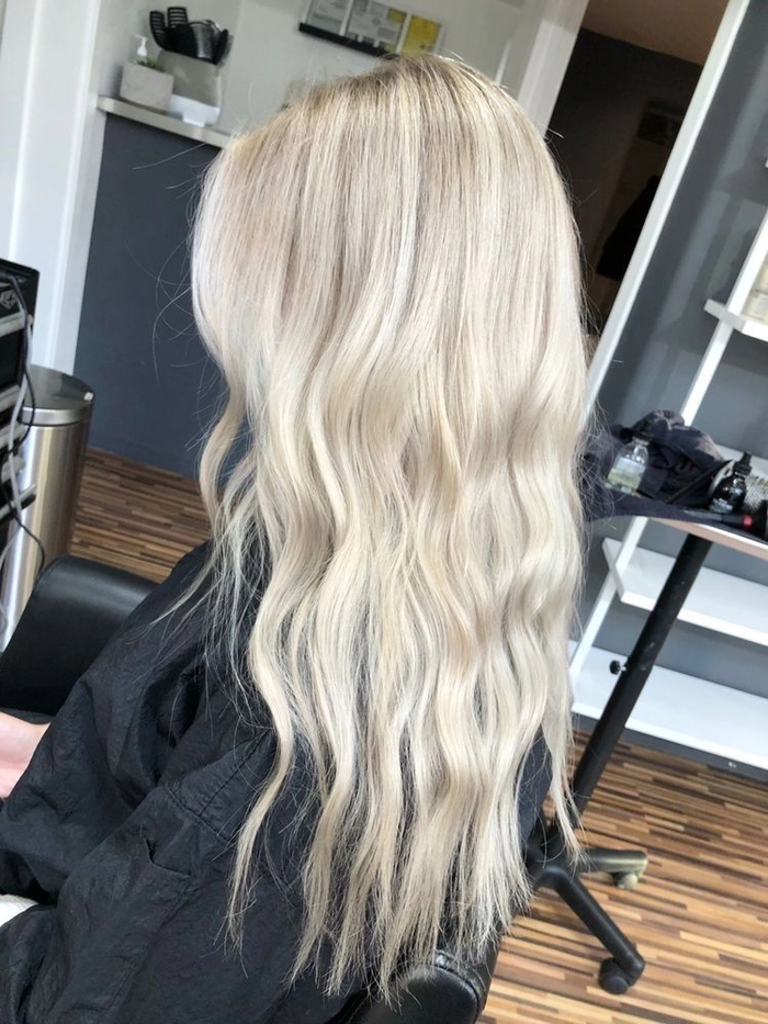 Winter bride with icy blonde toned hair styled in an elegant updo for holiday season