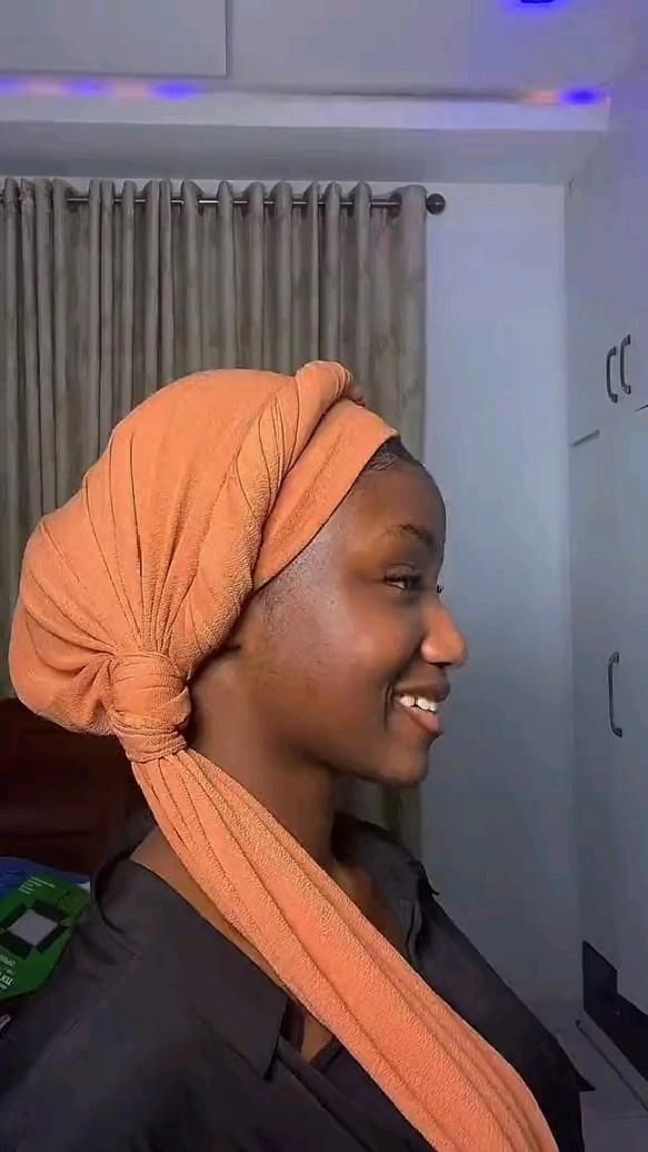 Modest Hair Covering Style for Hanukkah Celebrations A Jewish woman wearing a modest scarf styled elegantly for a Hanukkah dinner