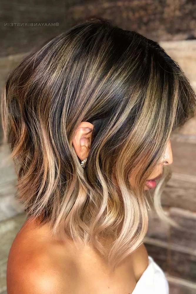 Woman with medium length thick hair styled in soft holiday waves for a festive celebration