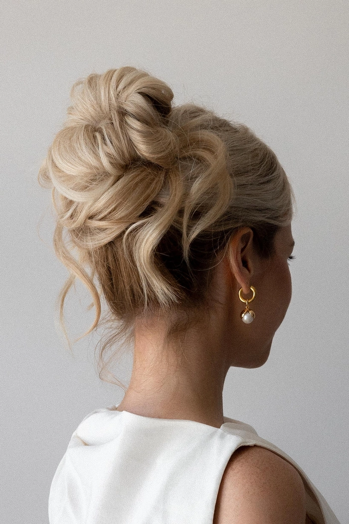 Elegant Diwali updo - perfect holiday hairstyle for festive celebrations Elegant updo hairstyle for Diwali with floral accents and traditional jewelry