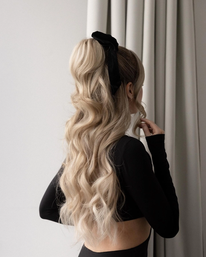 High ponytail inspiration for New Year's Eve clubbing, with sleek hair and festive accessories