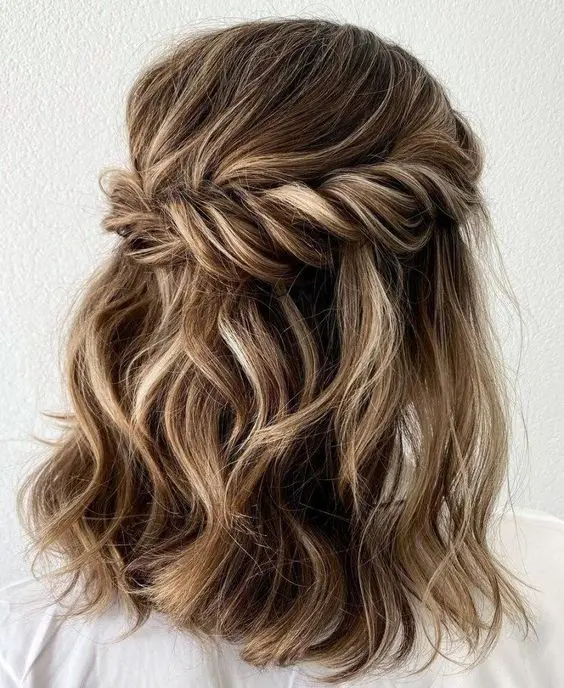 Romantic twisted halo hairstyle perfect for winter date nights Twisted halo updo with delicate winter accessories for a romantic date night look