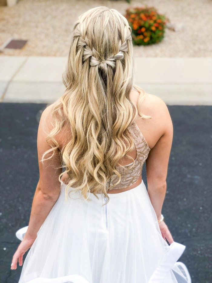 Model showcasing an elegant waterfall braid hairstyle tailored for a daytime holiday event