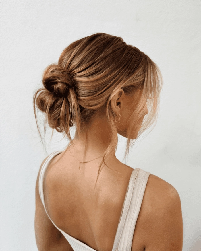 Woman with a polished low bun hairstyle suitable for holiday family events