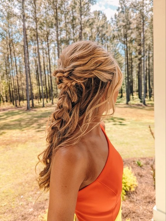 Prom night hairstyle inspiration for winter formals with a twisted chignon and pearl pins