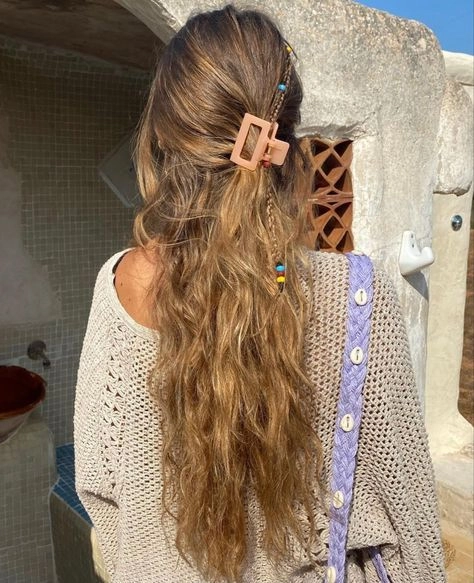 Labor Day end-of-summer hair transition trend featuring a sleek low bun with beach wave texture