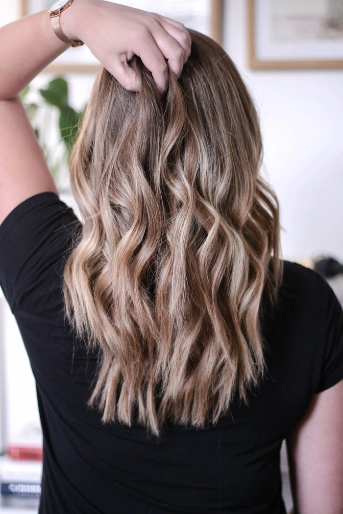 Medium length holiday waves styled on thick hair with festive flair