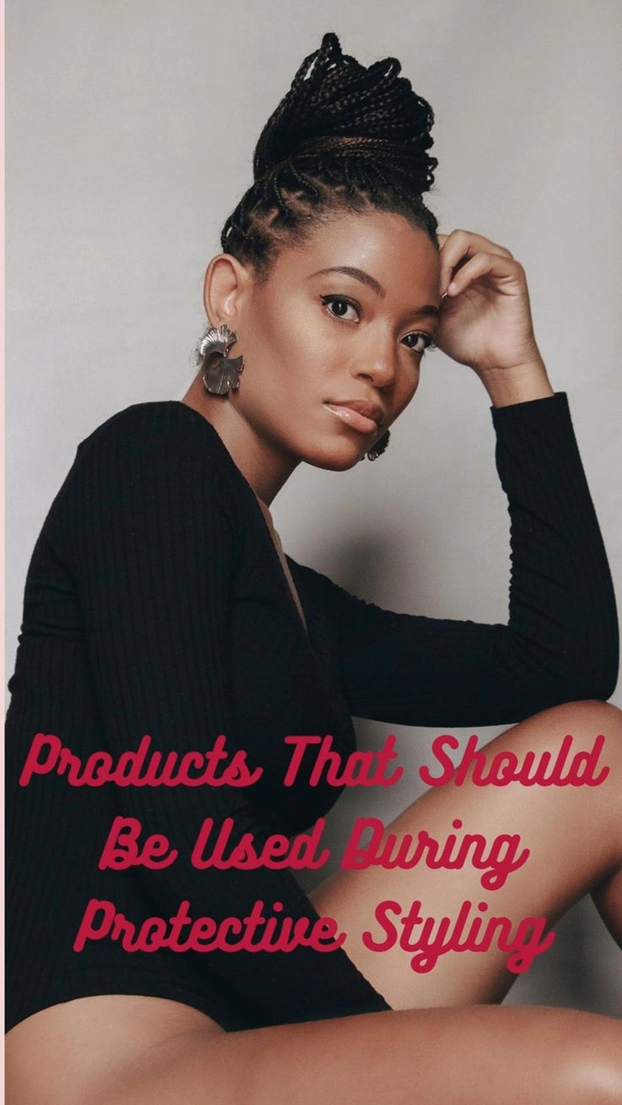 Protective Holiday Hairstyle for Winter: Elegant Braided Updo for Black Women A Black woman in a cozy winter setting wearing a stylish protective braided updo with subtle gold accessories