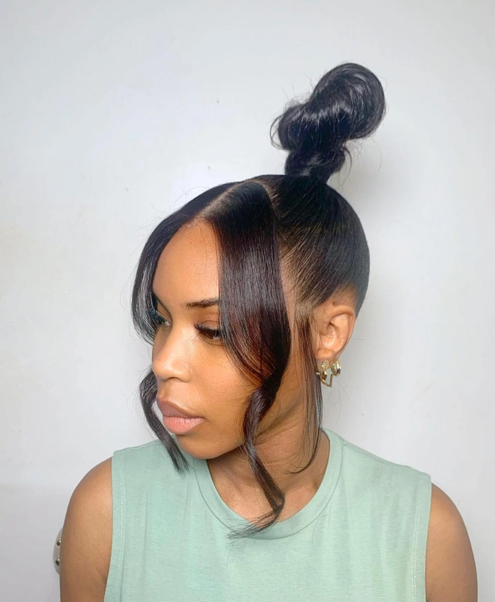 A chic minimalist holiday outfit paired with a sleek, polished top knot hairstyle