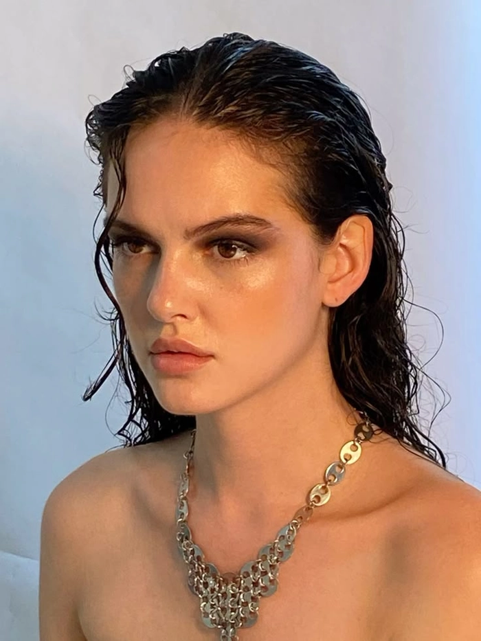 sleek wet look villain hairstyle inspiration for holiday glamour