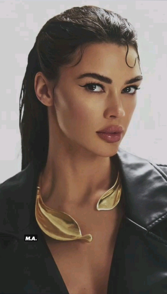 Sleek wet look hairstyle with villain-inspired edge for holiday party