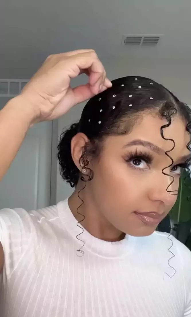 A sparkly hair clip placed in an elegant updo for a New Year's Eve gala hairstyle