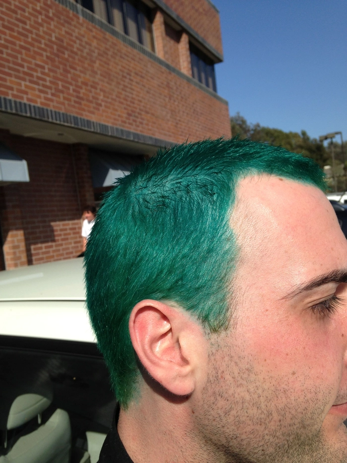 Creative St. Patrick's Day hairstyle using green hair chalk and glitter alternatives to spray