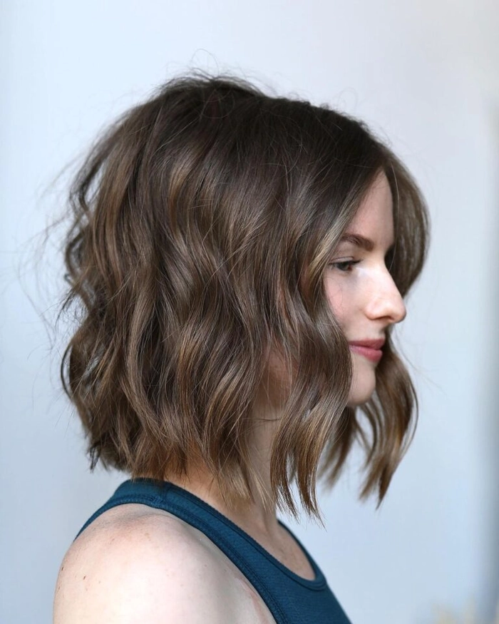 Textured lob hairstyle styled for a Friendsgiving party, showcasing soft waves and face-framing layers