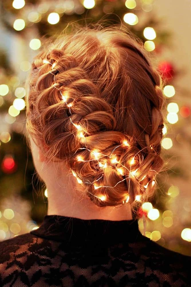 A thick hair holiday updo with braided crown and glitter pins for all-night hold